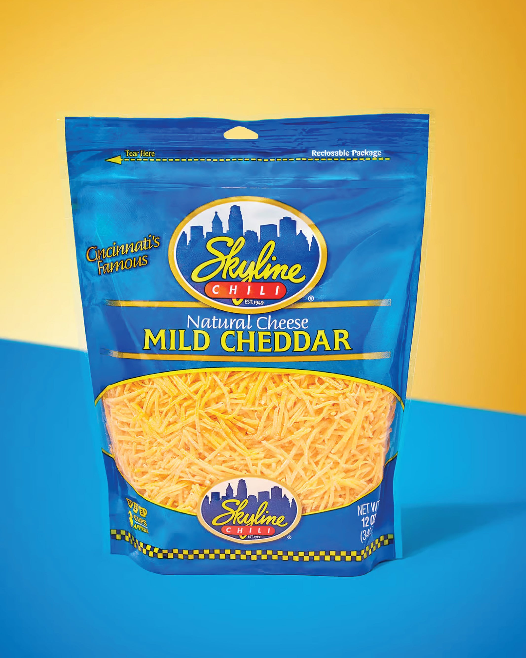 Bag of Skyline Chili Mild Cheddar cheese on a blue and yellow background
